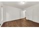 Bedroom featuring wood floors, white walls, and a closet for ample storage space at 4968 Twin Branches Way, Dunwoody, GA 30338