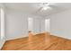 This bedroom features hardwood floors, a ceiling fan, and an en-suite bath at 4968 Twin Branches Way, Dunwoody, GA 30338