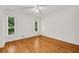 Bright bedroom with hardwood floors, white walls, ceiling fan and large windows at 4968 Twin Branches Way, Dunwoody, GA 30338