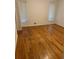 Well-lit bedroom featuring hardwood floors and windows for ample natural light at 4968 Twin Branches Way, Dunwoody, GA 30338