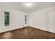 Bedroom with hardwood floors, neutral walls, crown molding, and windows with wooded views at 4968 Twin Branches Way, Dunwoody, GA 30338