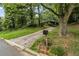 Long driveway leading to a secluded home amidst lush greenery at 4968 Twin Branches Way, Dunwoody, GA 30338