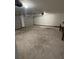 A two car garage featuring concrete flooring, white walls, and an overhead lighting fixture at 4968 Twin Branches Way, Dunwoody, GA 30338