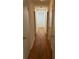 Long hallway featuring gleaming wood floors and white walls at 4968 Twin Branches Way, Dunwoody, GA 30338