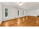 Bright living room featuring hardwood floors and multiple windows at 4968 Twin Branches Way, Dunwoody, GA 30338