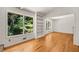 Bright living room with a bookshelf and a large window overlooking the yard at 4968 Twin Branches Way, Dunwoody, GA 30338