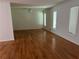 Bright living room with pristine wood floors and natural light from large windows at 4968 Twin Branches Way, Dunwoody, GA 30338
