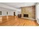 Large living room with a brick fireplace and hardwood floors at 4968 Twin Branches Way, Dunwoody, GA 30338