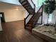 Open-concept living room with hardwood floors, staircase and natural light from a nearby window at 4968 Twin Branches Way, Dunwoody, GA 30338