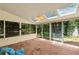 Bright sunroom featuring brick flooring, surrounded by windows with a view of the backyard at 4968 Twin Branches Way, Dunwoody, GA 30338
