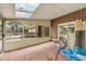 Enclosed sunroom with brick floors and windows, showcasing backyard and potential at 4968 Twin Branches Way, Dunwoody, GA 30338