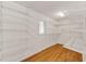 Walk-in closet with hardwood floors, custom shelving, and natural light at 4968 Twin Branches Way, Dunwoody, GA 30338