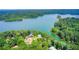 Stunning aerial view of a luxury home nestled on a lush peninsula with private access to a sparkling lake at 504 N Little Victoria Rd, Woodstock, GA 30189