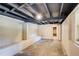 Unfinished basement featuring exposed rafters, concrete floor and cinder block walls at 504 N Little Victoria Rd, Woodstock, GA 30189