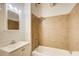 Bathroom featuring a tub with tile surround and a vanity with a sink, faucet, mirror, and lighting at 504 N Little Victoria Rd, Woodstock, GA 30189