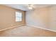 Bedroom features carpet flooring, ceiling fan, and good natural light from the window at 504 N Little Victoria Rd, Woodstock, GA 30189