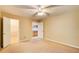 Bedroom with carpet, ceiling fan, closet and view to kitchen at 504 N Little Victoria Rd, Woodstock, GA 30189