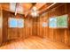 Bedroom with natural wood walls and ceiling, hardwood floors, ceiling fan, and natural light from two windows at 504 N Little Victoria Rd, Woodstock, GA 30189