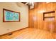 Bedroom with wood paneled accent wall, hardwood floors, window, and recessed shelving at 504 N Little Victoria Rd, Woodstock, GA 30189