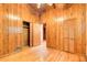 Bedroom with wood paneling, wood floors, and closet at 504 N Little Victoria Rd, Woodstock, GA 30189