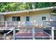 Charming home featuring an elevated deck and a serene, wooded backdrop at 504 N Little Victoria Rd, Woodstock, GA 30189