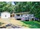 Exterior of home showcasing front deck and surrounding greenery at 504 N Little Victoria Rd, Woodstock, GA 30189