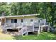 Charming home featuring an elevated deck and a serene, wooded backdrop at 504 N Little Victoria Rd, Woodstock, GA 30189