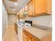 Classic kitchen featuring wooden cabinetry, laminate countertops and white appliances at 504 N Little Victoria Rd, Woodstock, GA 30189