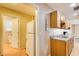 Kitchen with wooden cabinets, laminate countertops, sink and view to bathroom at 504 N Little Victoria Rd, Woodstock, GA 30189