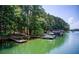 Scenic lake view with boat dock, perfect for enjoying waterfront living and recreational activities on a sunny day at 504 N Little Victoria Rd, Woodstock, GA 30189