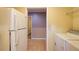 Laundry area with washer, dryer, and doorway to separate room at 504 N Little Victoria Rd, Woodstock, GA 30189