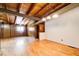 Spacious living room with hardwood floors, wood paneled accent wall, wood beam ceilings, and modern lighting at 504 N Little Victoria Rd, Woodstock, GA 30189