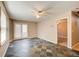 Living room featuring gray tile flooring, ceiling fan, and patio door access to outside at 504 N Little Victoria Rd, Woodstock, GA 30189