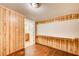 Versatile room featuring wood-paneled walls, hardwood floors, and a built-in desk at 504 N Little Victoria Rd, Woodstock, GA 30189