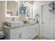 Bathroom with dual sinks, granite countertops, and decorative mirrors at 1165 Laurel Se Pl, Smyrna, GA 30080
