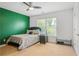 Cozy bedroom with a comfortable bed, large window, and calming green accent wall at 1165 Laurel Se Pl, Smyrna, GA 30080