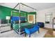 Primary bedroom with canopy bed, hardwood floors, and a sitting bench at 1165 Laurel Se Pl, Smyrna, GA 30080