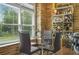 Eat-in nook features stone wall, display shelving, and views of the outdoors at 1165 Laurel Se Pl, Smyrna, GA 30080