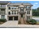 Beautiful townhome featuring a brick and tan exterior with a small front yard and two-car garage at 1165 Laurel Se Pl, Smyrna, GA 30080