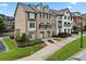Attractive townhome showing brick and siding, a manicured lawn, and a driveway leading to the attached garage at 1165 Laurel Se Pl, Smyrna, GA 30080