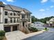 Inviting townhome featuring brick accents, private balconies, and convenient garage access at 1165 Laurel Se Pl, Smyrna, GA 30080