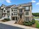 Charming townhome showcasing its brick and siding exterior, a small front yard, and an attached two-car garage at 1165 Laurel Se Pl, Smyrna, GA 30080