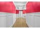 Hallway with red walls and white trim, leading to a decorative sitting area at 1165 Laurel Se Pl, Smyrna, GA 30080