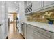 Kitchen with stone backsplash, marble countertops, wine cooler and stainless appliances at 1165 Laurel Se Pl, Smyrna, GA 30080