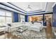 Bright living room with modern tray ceilings, large windows, hardwood floors, and an open view to the kitchen at 1165 Laurel Se Pl, Smyrna, GA 30080