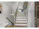 Staircase with white risers, wooden treads and handrail, and natural light at 1165 Laurel Se Pl, Smyrna, GA 30080