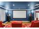Enjoy a cinematic experience in this home theater, complete with comfy seating and a large screen at 1165 Laurel Se Pl, Smyrna, GA 30080