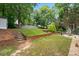 View of backyard with terraced landscaping, storage shed, and patio at 1297 Hadaway Trl, Lawrenceville, GA 30043