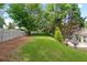 Beautiful backyard featuring lawn, patio, dining set, retaining wall, landscaping and a fence at 1297 Hadaway Trl, Lawrenceville, GA 30043