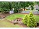 This beautiful backyard features a storage shed, retaining wall with landscape, and steps to the upper yard at 1297 Hadaway Trl, Lawrenceville, GA 30043